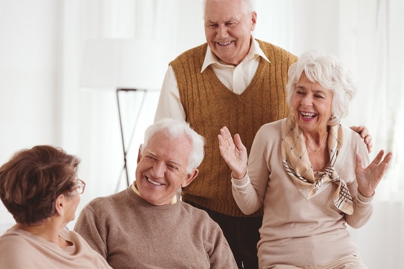 Happy senior old friends on a reunion at retirement club